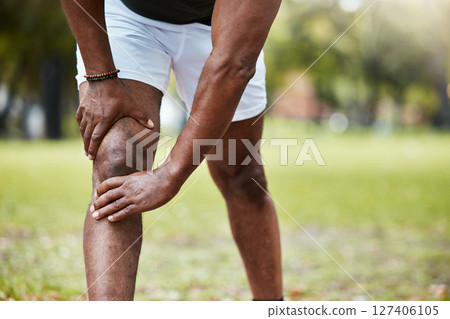 Sports, fitness and knee pain of black man at park after running outdoors. Healthcare, wellness and mature male runner with leg injury, muscle pain or joint inflammation after training or workout. 127406105