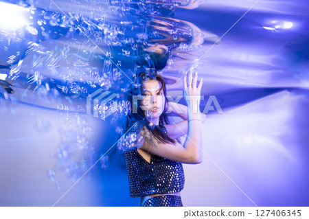 Girl Embodies a Fabulous Mermaid in a Whimsical Underwater Setting Surrounded by Shimmering Bubbles 127406345