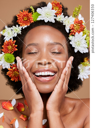 Flowers, beauty and black woman with smile, happy and skincare plants in brown studio background. Spring, healthy skin and nature girl model with flower, face and advertising facial cosmetic product Flowers, beauty and black woman with smile, happy and skincare plants in brown studio background. Spring, healthy skin and nature girl model with flower, face and advertising facial cosmetic product 127406350