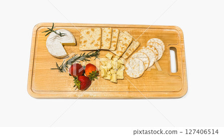 Appetizer different types of cheeses on cutting board with fresh strawberries isolated in white background. Appetizer different types of cheeses on cutting board with fresh strawberries isolated in white background. 127406514