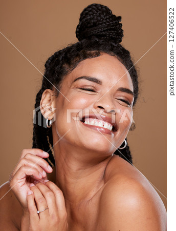 Skincare, wellness and happy black woman in studio for a health, cosmetic and natural skin routine. Beauty, happiness and African model with cosmetics, makeup or facial treatment by brown background. Skincare, wellness and happy black woman in studio for a health, cosmetic and natural skin routine. Beauty, happiness and African model with cosmetics, makeup or facial treatment by brown background. 127406522