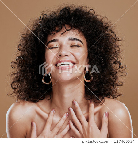 Beauty, skincare and self love of a black woman with natural hair feeling happiness and pride for identity on a brown studio background. Aesthetic model happt about cosmetics, makeup and glow on skin 127406534