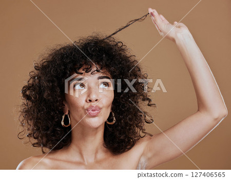 Hair care, black woman and hairstyle health texture of a model holding afro to show salon results. Beauty, skincare and natural skin glow of a young woman think about cosmetic wellness and hair style 127406565