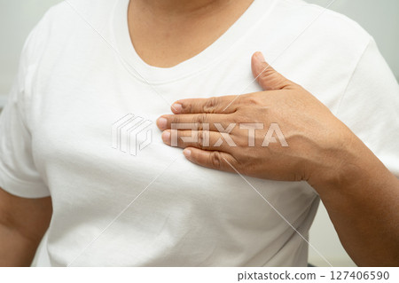 Asian woman patient checking and worry her breast, Breast Self Exam or BES, symbol of World Breast Cancer Day. Asian woman patient checking and worry her breast, Breast Self Exam or BES, symbol of World Breast Cancer Day. 127406590