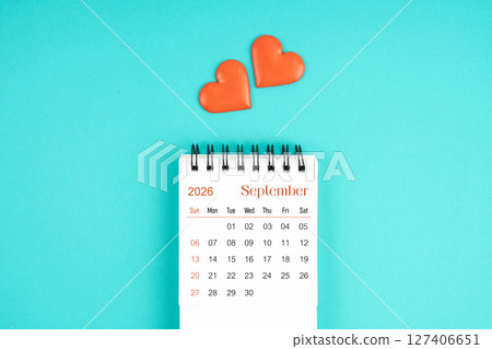 September 2026 desk calendar with red heart on blue color background. 127406651