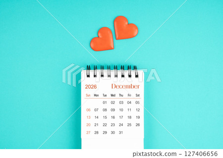 December 2026 desk calendar with red heart on blue color background. 127406656