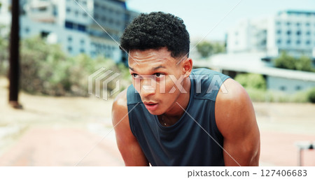 Athlete, man and tired with breathing at stadium for running fatigue, race competition and burnout. Fitness workout, runner or sweating outdoor for marathon recovery, endurance challenge or exhausted 127406683
