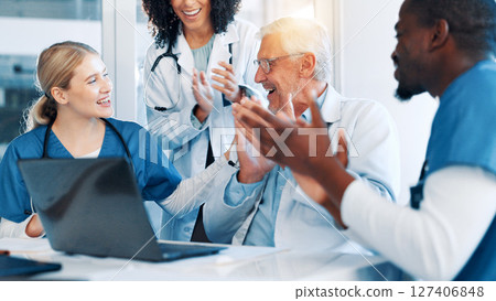 Doctors, man and team with applause, laptop and support with goals, results and celebration. People, group and women with staff for success, praise or achievement in career with cheers at hospital 127406848