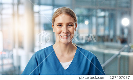 Smile, medical and portrait of woman nurse in hospital for about us, service and confidence. Happy, healthcare and scrubs with friendly medicine professional in clinic for medicare or therapy 127407087