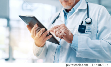 Hands, doctor or man in hospital, tablet or typing with email for shift schedule. Medical, person or tech with professional, healthcare or online reading for diagnosis report or research in clinic 127407103