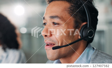 Headset, man and call center consultant in office for lead generation, crm or help desk consultation. Audio tech, customer service and male technical support agent with online query in workplace. 127407382