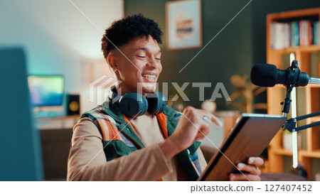 Man, streamer and tablet in home with smile, mic and typing with script editing for video production. Gen z influencer, happy and app for chat, click and subscription list on social media at house Man, streamer and tablet in home with smile, mic and typing with script editing for video production. Gen z influencer, happy and app for chat, click and subscription list on social media at house 127407452