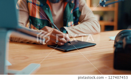 Person, hands and editor with tablet pen for drawing, sketching or digital design at home. Closeup, creative or artist with technology for multimedia production, retouch or photo editing software Person, hands and editor with tablet pen for drawing, sketching or digital design at home. Closeup, creative or artist with technology for multimedia production, retouch or photo editing software 127407453