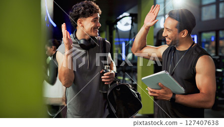 Men, personal trainer and tablet with high five at gym with smile, success or cheers for exercise goals. People coach and touchscreen with app for training, happy or congratulations at fitness center Men, personal trainer and tablet with high five at gym with smile, success or cheers for exercise goals. People coach and touchscreen with app for training, happy or congratulations at fitness center 127407638