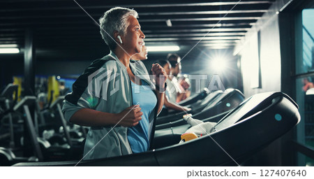 Runner, earphones and music with woman on treadmill for workout playlist, training club and health. Gym membership, exercise and fitness podcast with mature person on running machine for radio Runner, earphones and music with woman on treadmill for workout playlist, training club and health. Gym membership, exercise and fitness podcast with mature person on running machine for radio 127407640