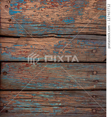 Multiple weathered wooden planks with chipped paint outdoors Multiple weathered wooden planks with chipped paint outdoors 127407712