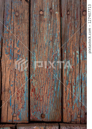 Multiple weathered wooden planks with peeling paint outdoors Multiple weathered wooden planks with peeling paint outdoors 127407713
