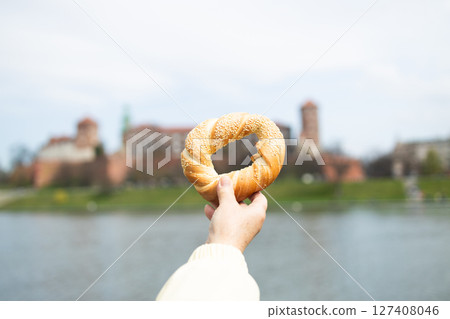 Traditional Obwarzanek Held in Front of Wawel Castle Traditional Obwarzanek Held in Front of Wawel Castle 127408046