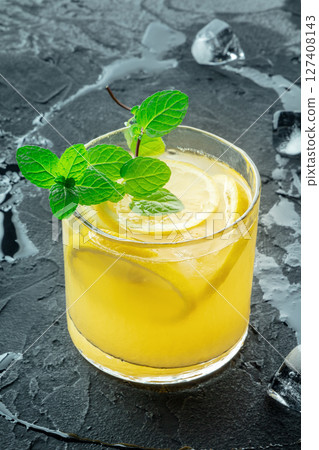 A glass of lemonade, a mocktail with lemon juice, on a black background 127408143