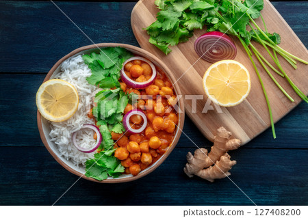 Chana masala, chickpea curry, traditional Indian dish, overhead flat lay shot Chana masala, chickpea curry, traditional Indian dish, overhead flat lay shot 127408200