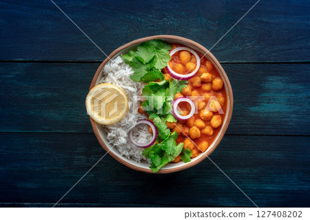 Chana masala, chickpea curry, traditional Indian dish, overhead flat lay shot Chana masala, chickpea curry, traditional Indian dish, overhead flat lay shot 127408202