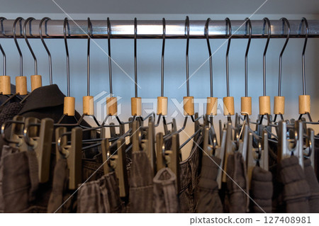 Stylish clothing arranged on hangers in a boutique. High quality photo Stylish clothing arranged on hangers in a boutique. High quality photo 127408981