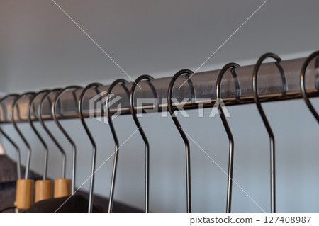 Stylish clothing arranged on hangers in a boutique. High quality photo Stylish clothing arranged on hangers in a boutique. High quality photo 127408987