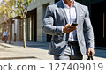 Stylish businessman shining in the summer light 127409019