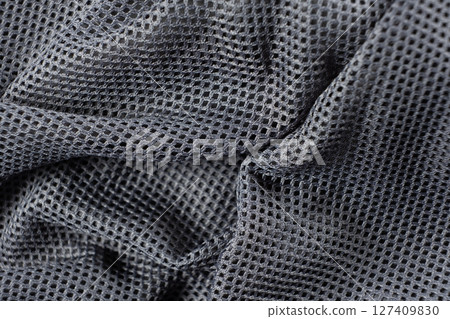 Synthetic polyester fabric macro top view, gray fabric background 127409830