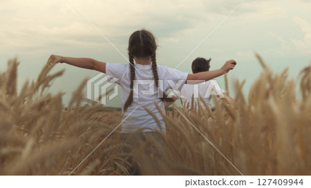 Agriculture, Wheat Field, Golden Wheat Farm Field Sunset, funny children running across field playing airplane pilot. agriculture concept. kids toddlers, year across field outdoors. children, toddler Agriculture, Wheat Field, Golden Wheat Farm Field Sunset, funny children running across field playing airplane pilot. agriculture concept. kids toddlers, year across field outdoors. children, toddler 127409944