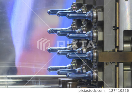 Close up scene of injection process group of preform shape of PET bottle products. 127410226