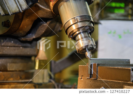 The chamfering process on NC milling machine with chamfer tools in the light blue scene. 127410227