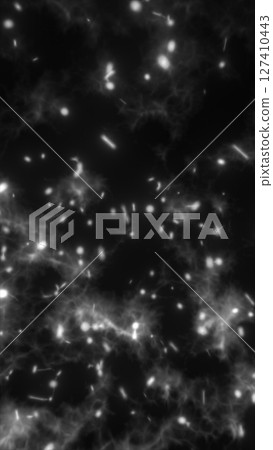 Vivid explosion of glowing particles around a black central void in radial formation 127410443