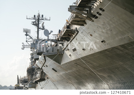 Close-up view of the USS upper deck featuring radar antennas, satellite dishes, and steel structures. The image highlights the ship's military communication and navigation systems. 127410671