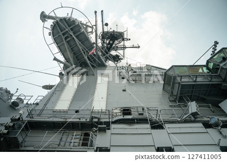 Low-angle view of the USS Intrepid's command tower featuring satellite dishes, antennas, and viewing platforms. The steel structure reflects the carrier s role in naval communication and observation. Low-angle view of the USS Intrepid's command tower featuring satellite dishes, antennas, and viewing platforms. The steel structure reflects the carrier s role in naval communication and observation. 127411005