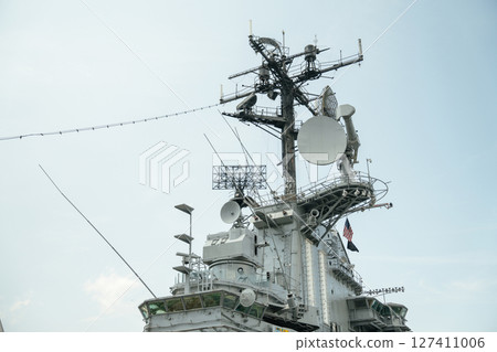 A detailed view of the communication and radar tower aboard the USS Intrepid, located at the Intrepid Sea, Air, Space Museum in New York City. The structure features antennas, satellite dishes, and A detailed view of the communication and radar tower aboard the USS Intrepid, located at the Intrepid Sea, Air, Space Museum in New York City. The structure features antennas, satellite dishes, and 127411006