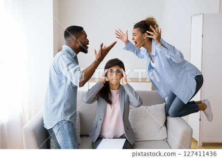 Shocked Marital Therapist Watching Black Couple Shouting And Blaming Each Other On Therapy Session. Selective Focus Shocked Marital Therapist Watching Black Couple Shouting And Blaming Each Other On Therapy Session. Selective Focus 127411436