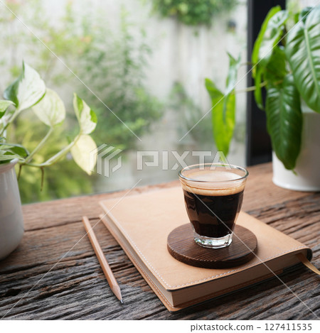 Coffee and notebook by the window 127411535