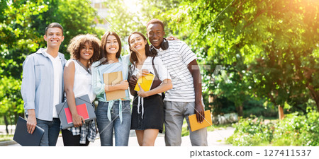 College Friendship Concept. Happy Multiethnic Group Of Students Posing Outdoors, Embracing And Smiling At Camera, Free Space 127411537