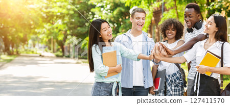 University Friendship. Portrait Of Joyful International Students Joining Hands, Having Fun Together Outdoor In Campus University Friendship. Portrait Of Joyful International Students Joining Hands, Having Fun Together Outdoor In Campus 127411570