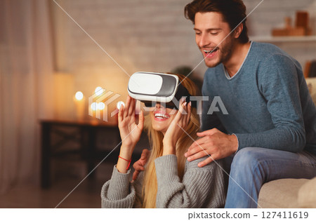 Virtual Reality. Excited Couple Using VR Glasses Playing Videogame Having Fun Sitting On Floor At Home Virtual Reality. Excited Couple Using VR Glasses Playing Videogame Having Fun Sitting On Floor At Home 127411619