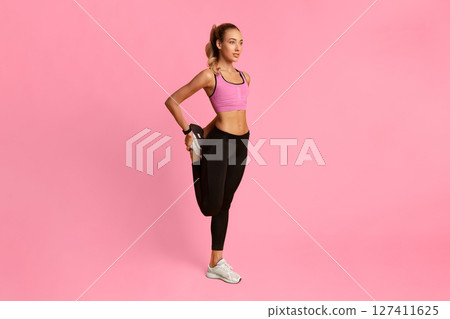Sporty Lady Warming Up Stretching Leg Before Workout Training Over Yellow Background. Full Length Sporty Lady Warming Up Stretching Leg Before Workout Training Over Yellow Background. Full Length 127411625