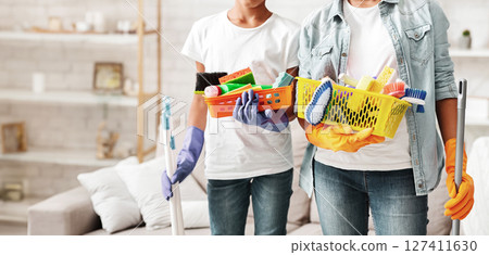 Cropped image of african girls holding cleaning tools, home interior 127411630