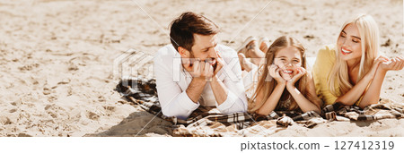 Summer Concept. Family Relaxing Lying On Plaid Having Picnic Outside In Nature Enjoying Sunny Day And After-Quarantine Life. Panorama 127412319