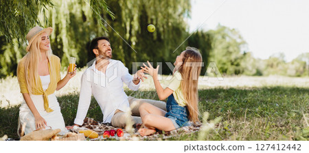 Summer Picnic. Joyful Family Of Three Having Fun Sitting On Blanket In Green Park On Sunny Day After Quarantine. 127412442