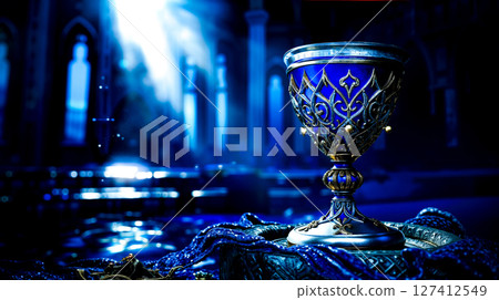 A silver chalice sitting on top of a table in a church 127412549