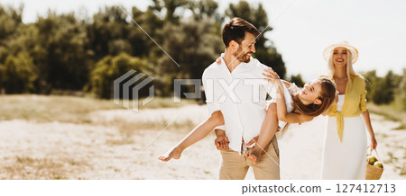 Family weekends. Father piggybacking his daughter, having fun in nature 127412713