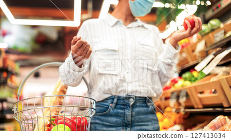 Grocery Shopping Concept. African Woman Buying Fresh Organic Vegetables Standing With Shop Trolley Cart In Supermarket Groceries Store Indoors. Customer Choosing Healthy Food. Cropped, Selective Focus Grocery Shopping Concept. African Woman Buying Fresh Organic Vegetables Standing With Shop Trolley Cart In Supermarket Groceries Store Indoors. Customer Choosing Healthy Food. Cropped, Selective Focus 127413034