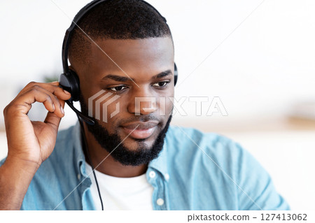 Closeup Portrait Of Handsome Black Male Hotline Operator In Headset, Young African American Customer Support Manager In Headphones Consulting Client, Working At Home Office, Free Space Closeup Portrait Of Handsome Black Male Hotline Operator In Headset, Young African American Customer Support Manager In Headphones Consulting Client, Working At Home Office, Free Space 127413062