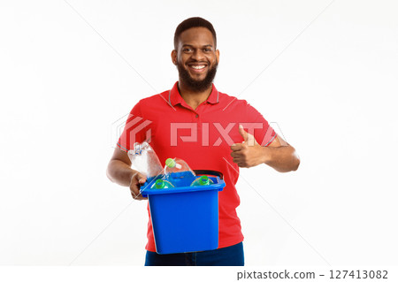 African American Male Holding Bucket With Recycle Symbol And Wasted Plastic Bottles Gesturing Thumbs Up Approving Waste Sorting Standing Over White Background, Studio Shot 127413082